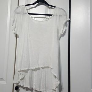 White shirt. Lace pattern back with tie on top.